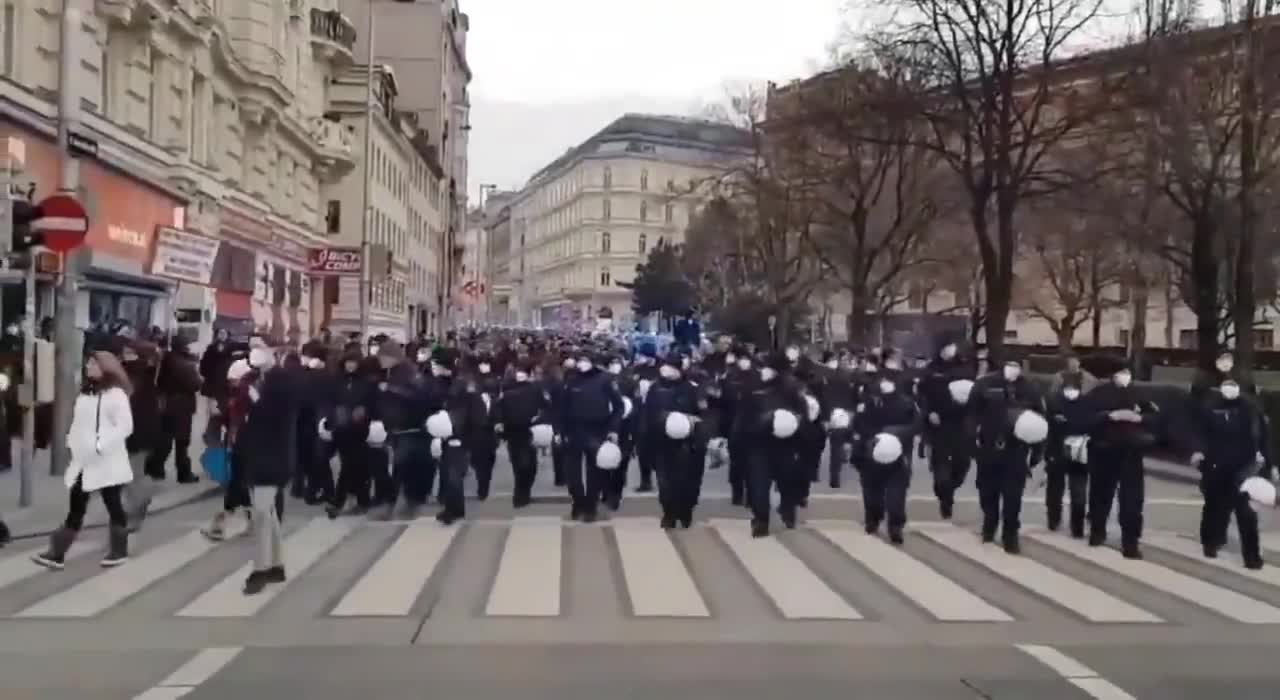 Police marching with the crowd against lockdown