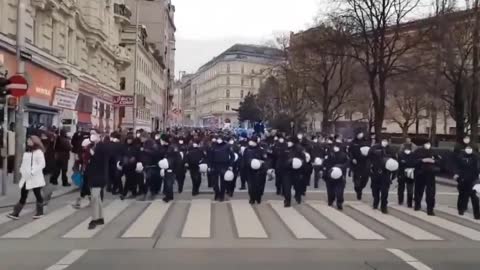 Police marching with the crowd against lockdown