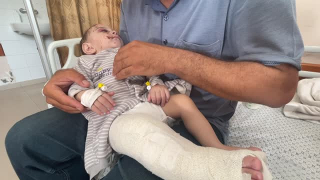 'No one left but you': Bereaved Gaza father clutches wounded baby boy
