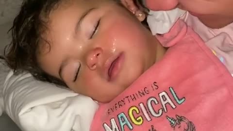 Sweet baby adorably laughs in her sleep