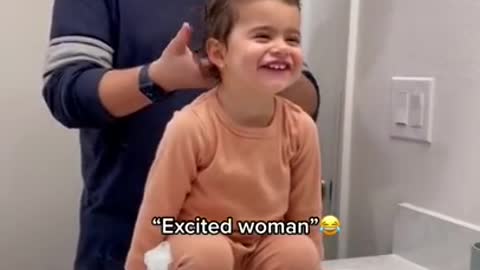 Dad is sharing a sweet moment with his daughter while doing her hair!