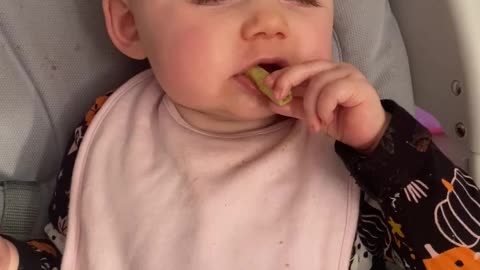 Tired baby goes into sleep mode while eating snack