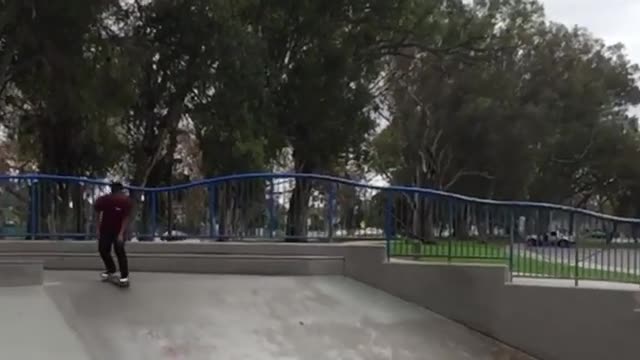 Maroon skateboard trick back slam