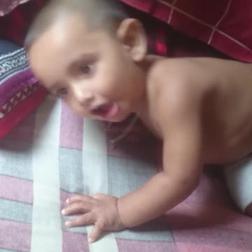 Cute boy Arham playing with pen.