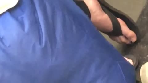 Zooming in on man with sandals 
