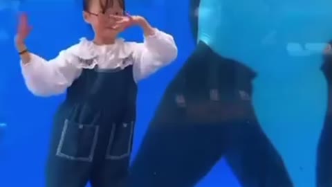 Little girl and a Dolphin dancing