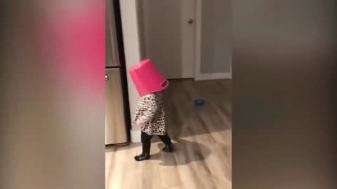 Poor Baby Wearing A Bucket Helmet Gets Struck on the Fridge