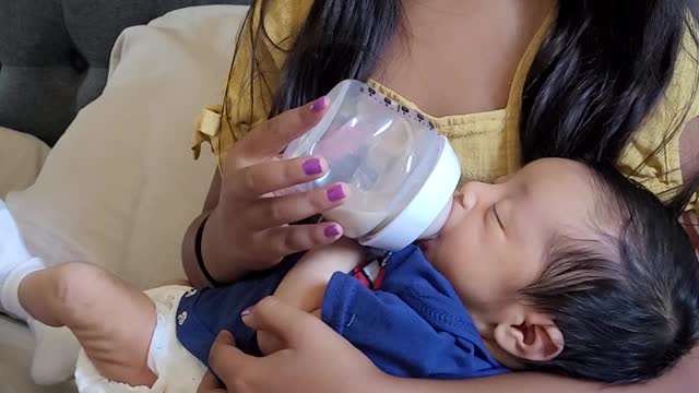 Daughter holding newborn baby brother