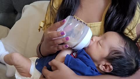 Daughter holding newborn baby brother