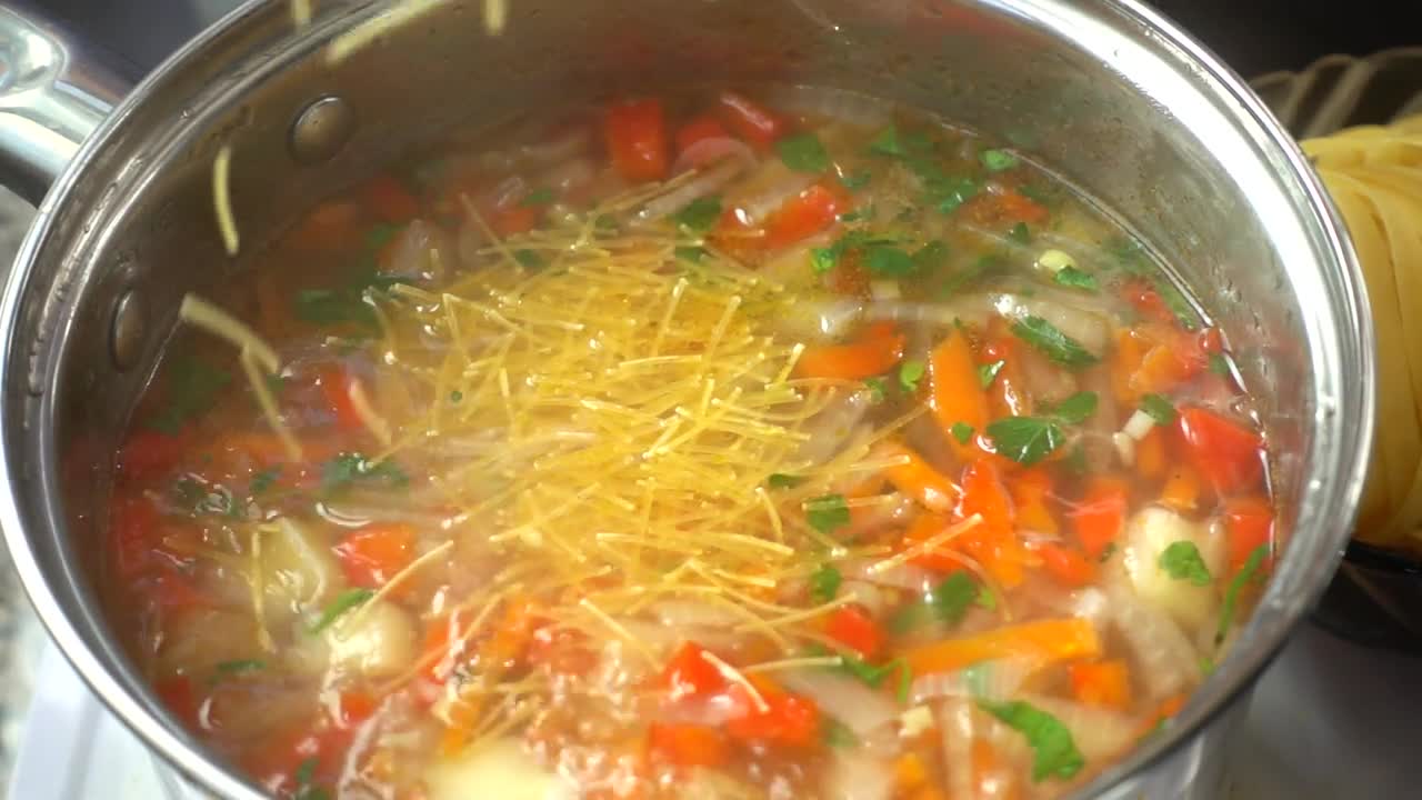 Preparing vegetable and pasta soup