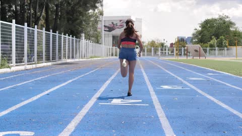 Woman running fast on a running track