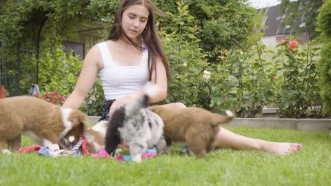 A young beautiful Caucasian woman plays with cute