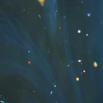Blue liquid superimposed on space with stars and galaxies