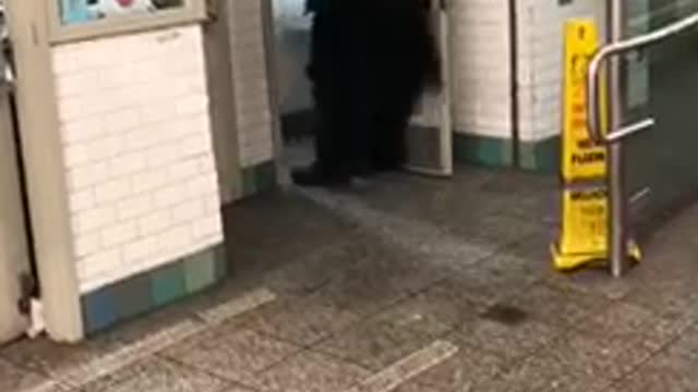 Man in batman costume walks out of restroom