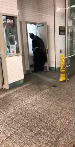 Man in batman costume walks out of restroom