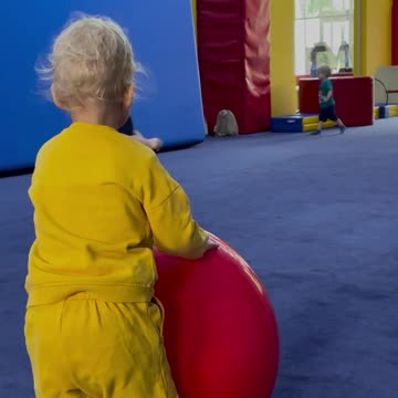Many Baby Kids Are Playing With Colorful Balls