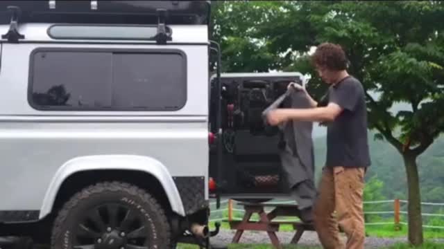 A man camping alone in the rain