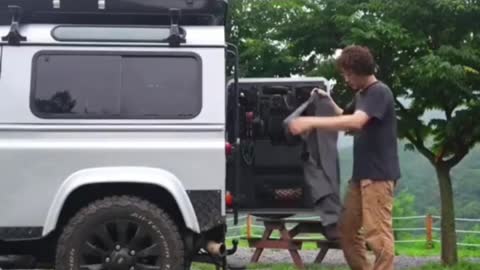 A man camping alone in the rain