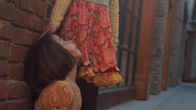 Two Girls Wearing Floral Dresses Playing Outside