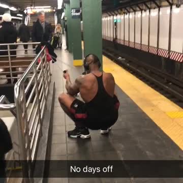 Man in black shirt exercising arms