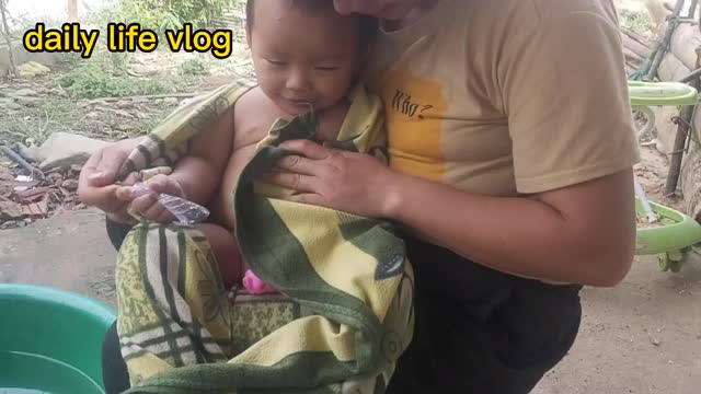 Baby bathed, but mother wrapped a towel to avoid the cold