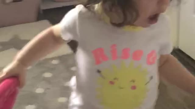 Calmly playing with her toys