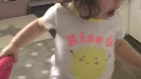 Calmly playing with her toys