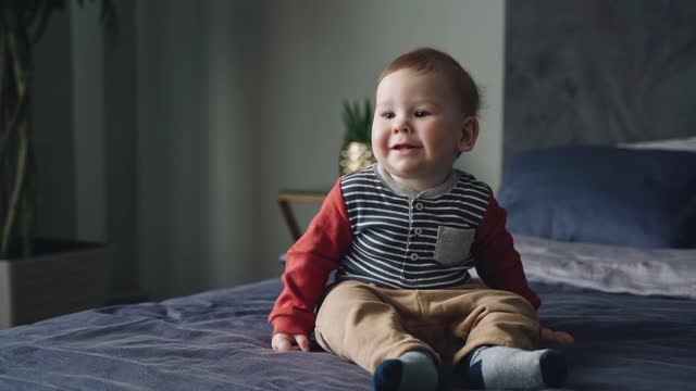 Baby boy sitting on and smile