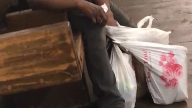 Homeless man straw and pens in his ear