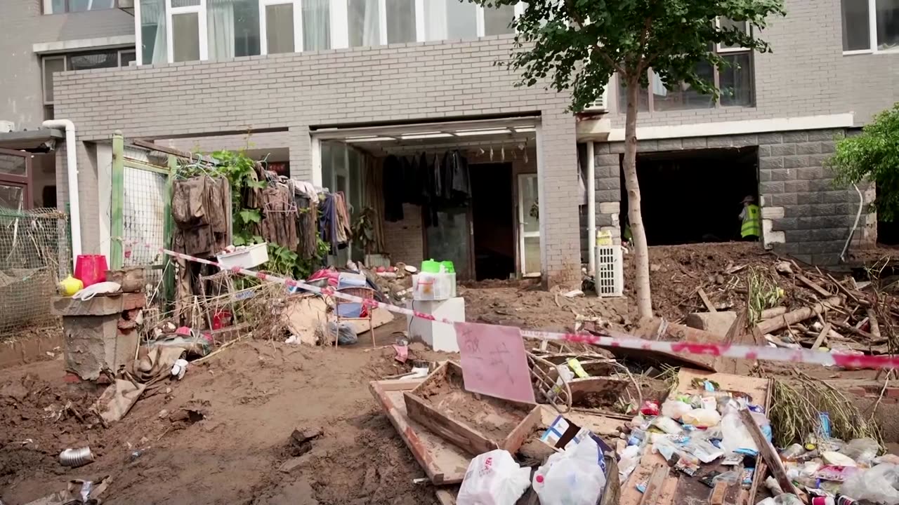 Man 'runs for his life' after historic China floods