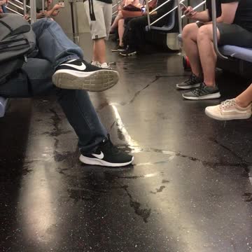 Subway train dancer black hat white shorts