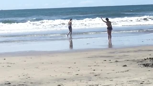 Woman doing tai chi stretches on beach