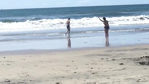 Woman doing tai chi stretches on beach