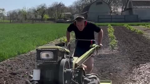 The guy pulls himself up on a tillerblock while working