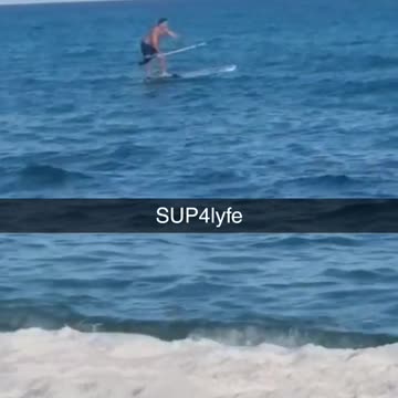 Man in blue swim shorts falls off paddle board