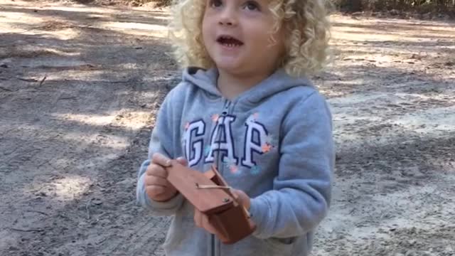 Little Girl Does Turkey Call with Wooden Contraption