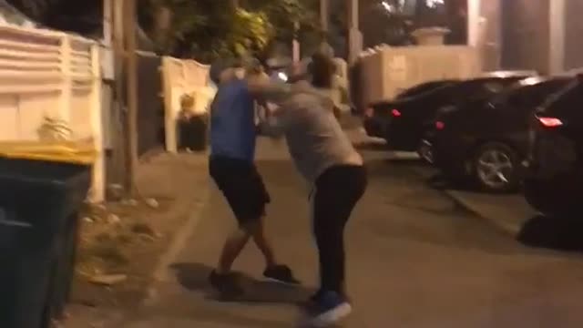 Blue shirt guy white shirt guy fighting in street key west both fall down same time