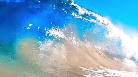 The inside of a beautiful, blue, breaking wave