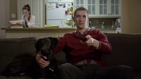 Man and dog watching TV together