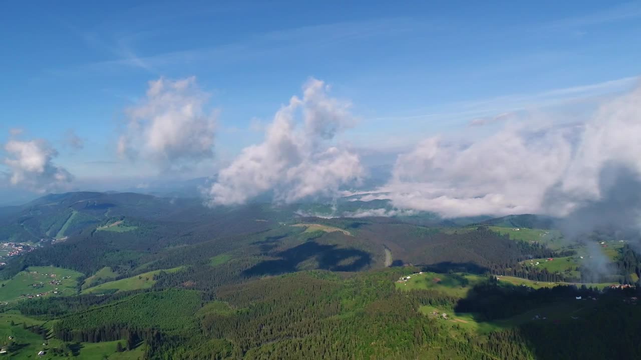 Flying at cloud level with the mountains below