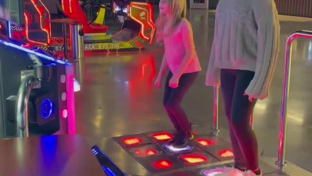 Sisters duel at Dance Dance Revolution