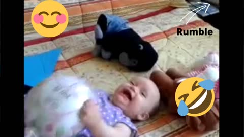 Beautiful baby laughing with a balloon