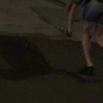 Kids crossing road with black surf board
