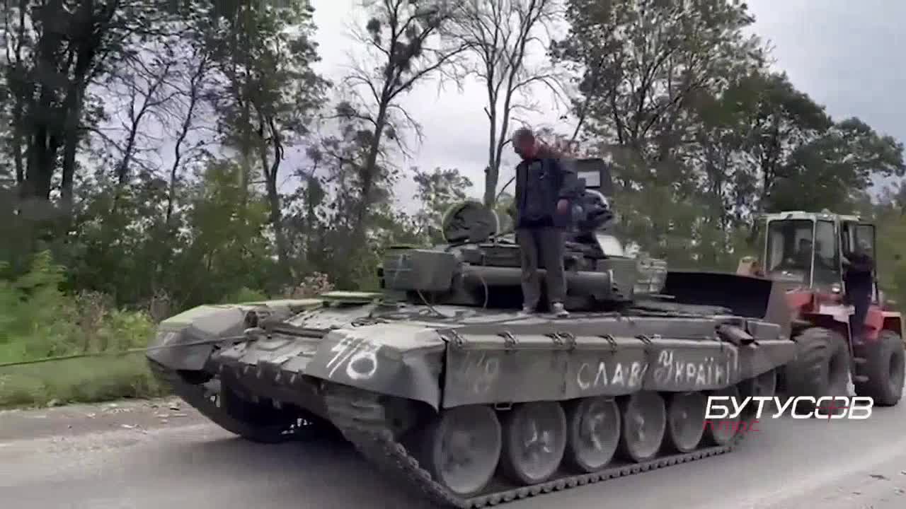 Ukrainian tractor drivers take out a captured Russian T-72B3 tank near Izyum.