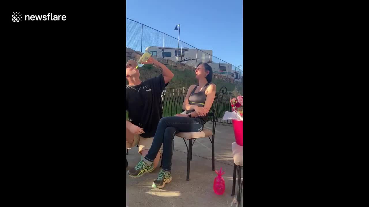 The look of disappointment! Mother dismayed as son downs whole bottle of wine