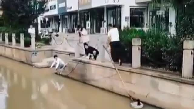 Two Men Rescue A Stranded Cat From Under A Bridge
