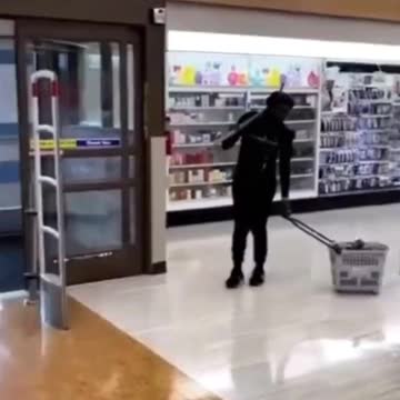 Shocking video shows woman armed with a PICKAXE shoplifting