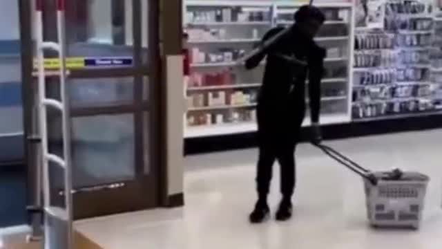 Shocking video shows woman armed with a PICKAXE shoplifting