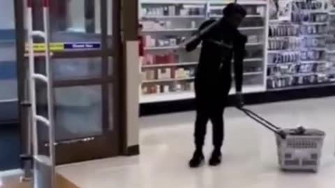 Shocking video shows woman armed with a PICKAXE shoplifting