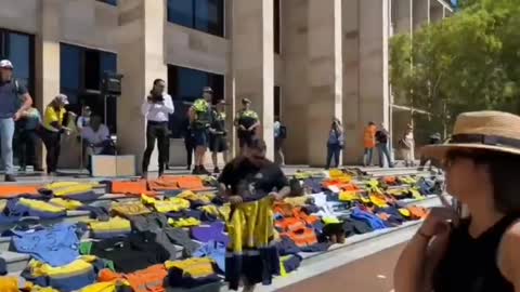 Patriots in Australia laying down their work uniforms on the steps of parliament.